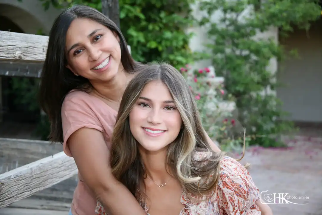 Mom daughter pose together during high school senior photo session